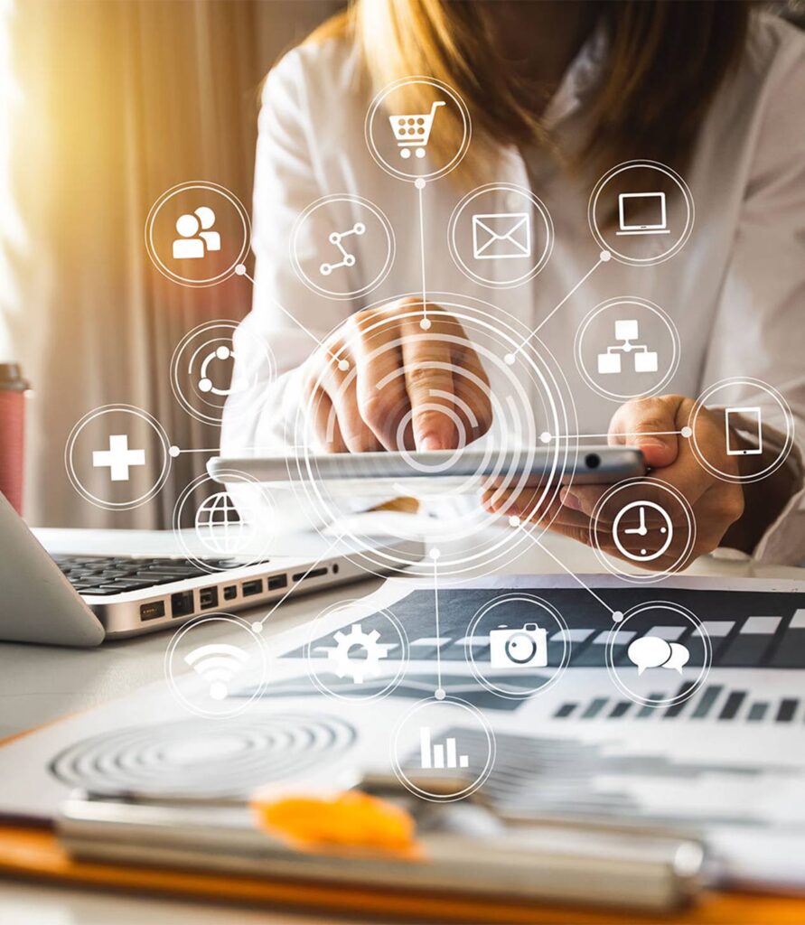 Person using a tablet with digital marketing icons overlayed in a work environment.
